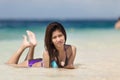 Filipina woman lying on sand