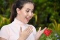 Surprised Youthful Diverse Female With Flowers