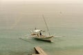 Filipino Banca boats being drenched by a midday rain