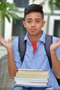 Filipino Boy Student And Indecisiveness With Notebooks