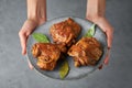 Filipino Chicken Adobo on gray plate on concrete backdrop. Filipino food. Braised chicken thighs