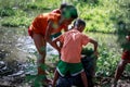 Filipino Children picking up trash near Mount Pinatubo on Aug 27, 2017 in Santa Juliana, Capas, Central Luzon, Philippines