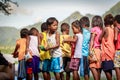 Filipino children standing in a line and holding snack in their