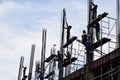 Filipino construction steel-men working joining column steel pieces on board scaffolding pipes on high-rise building