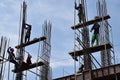 Filipino construction steel-men working joining column steel pieces on board scaffolding pipes on high-rise building