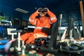 Filipino deck Officer on bridge of vessel or ship looking through binoculars