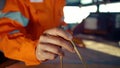 Filipino deck Officer on bridge of vessel or ship. He is plotting position on chart