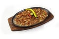 Filipino dish called Sisig or chopped pig face served with egg and chilli on a sizzling plate Royalty Free Stock Photo