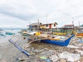 Filipino fishing boat in a sea of junk Royalty Free Stock Photo