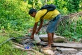 A Filipino man accesses clean water directly from the municipal water pipe.