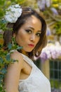 Filipino model in front of a house in a garden at springtime