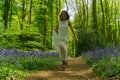 Filipino model running through a bluebell wood Royalty Free Stock Photo