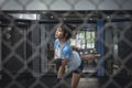 A Filipino Muay Thai athlete stretches her leg in the octagon ring cage before her match Royalty Free Stock Photo