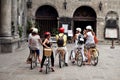 Filipino people guide and foreign travelers travel visit San Agustin Church and use bicycle biking on street tour around