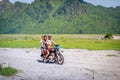 Filipino people riding motorcycle along the volcanic field near