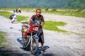 Filipino people riding motorcycle along the volcanic field near