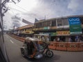 A Filipino tricycle driver riding his vehicle