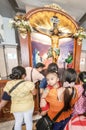 Filipino visitors, at the Basilica of Saint Nino,queue to pray at the feet of Jesus