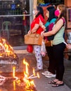 Filipinos gather to pray and light religious candles,at a holy shrine next to the iconic Dumaguete Belfry,that helped save the