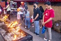 Filipinos gather to pray and light religious candles,at a holy shrine next to the iconic Dumaguete Belfry,that helped save the