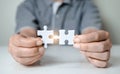 Fill the missing parts of hand white jigsaw concept puzzle for succeed