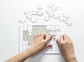 Fill the missing parts of hand white jigsaw concept puzzle for succeed