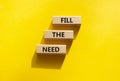 Fill the need symbol. Concept word Fill the need on wooden blocks. Beautiful yellow background. Business and Fill the need concept