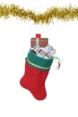 Filled christmas stocking hanging on gold garland