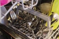 Filled cutlery basket in a dishwasher Royalty Free Stock Photo