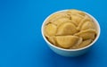 Filled dumplings, russian vareniki, pelmeni on blue background