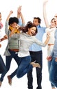 Filled with energy. Group of casually dressed young adults jumping excitedly against a white background. Royalty Free Stock Photo