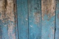 Filled frame close up background wallpaper shot of an old ragged and scuffed blue turquoise painted wooden wall forming beautiful