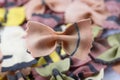 Filled frame close up top view flat lay background wallpaper shot of a single red and black raw Italian bow tie farfalle on a Royalty Free Stock Photo