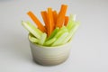 filled frame  shot of a brown beige bowl filled with crunchy orange carrot pieces and juicy green celery sticks Royalty Free Stock Photo