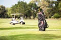 Filled golf bag and golf buggy Royalty Free Stock Photo
