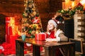 Filled with happiness cheer and love. Girl enjoy cozy warm atmosphere christmas eve. Christmas joy. Woman wooden