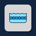 Filled outline Swimming pool icon isolated on blue background. Vector