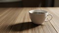 Filled with steaming coffee sits on a wooden table with a smooth grainy Royalty Free Stock Photo