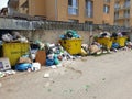 Filled trash cans in populated area in Floresti