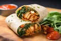 a filled wrap with vegan chicken and sriracha