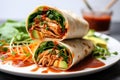 a filled wrap with vegan chicken and sriracha