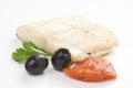 Fillet of cod baked tomatoes zucchini black olives Royalty Free Stock Photo