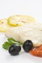 Fillet of cod baked tomatoes zucchini black olives Royalty Free Stock Photo