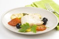 Fillet of cod baked tomatoes zucchini black olives Royalty Free Stock Photo