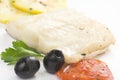 Fillet of cod baked tomatoes zucchini black olives Royalty Free Stock Photo