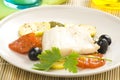 Fillet of cod baked tomatoes zucchini black olives Royalty Free Stock Photo