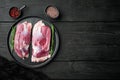 Fillet of duck uncooked, raw meat, on plate, on black wooden table background, top view flat lay, with copyspace  and space for Royalty Free Stock Photo