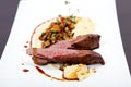 Fillet of lamb with polenta, gravy, vegetables and spice Royalty Free Stock Photo