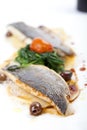 Fillet of sea bass with ravioli, spinach and olives