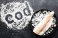 Fillet of white sea cold-water fish cod in ice cubes on a dark background. Top view Royalty Free Stock Photo